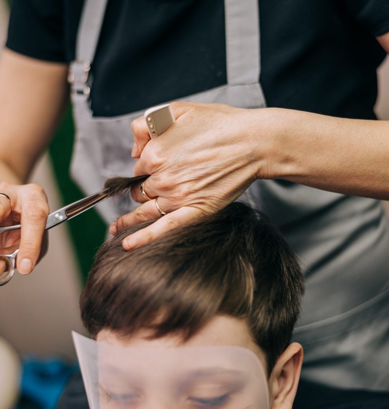 little-kid-boy-in-the-barbershop-or-hairdressing-saloon-barber-is-doing-haircut-for-a-toddler.jpg